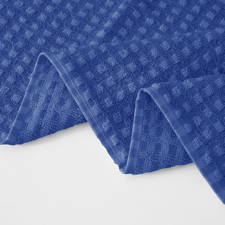 Blue textured towel on a white background