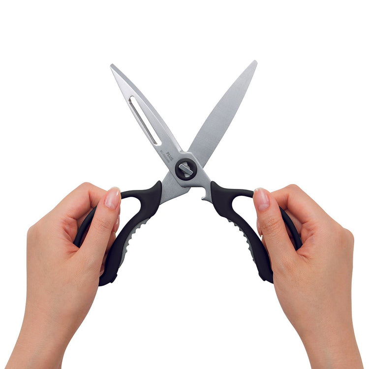 Hands holding a pair of scissors on a white background