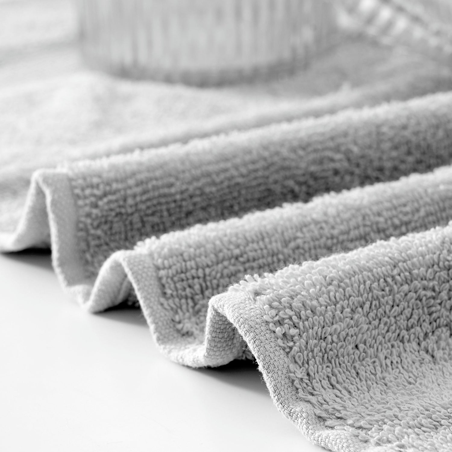 Stack of gray towels on a white surface