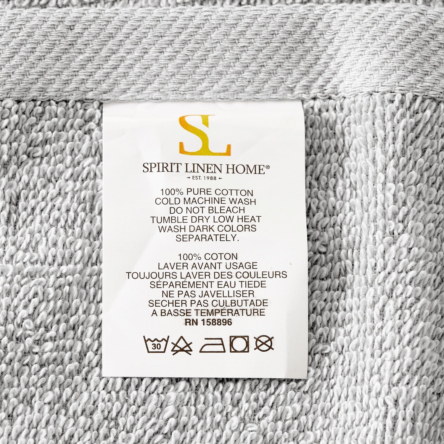 Fabric label with 'Spirit Linen Home' branding on a textured fabric background