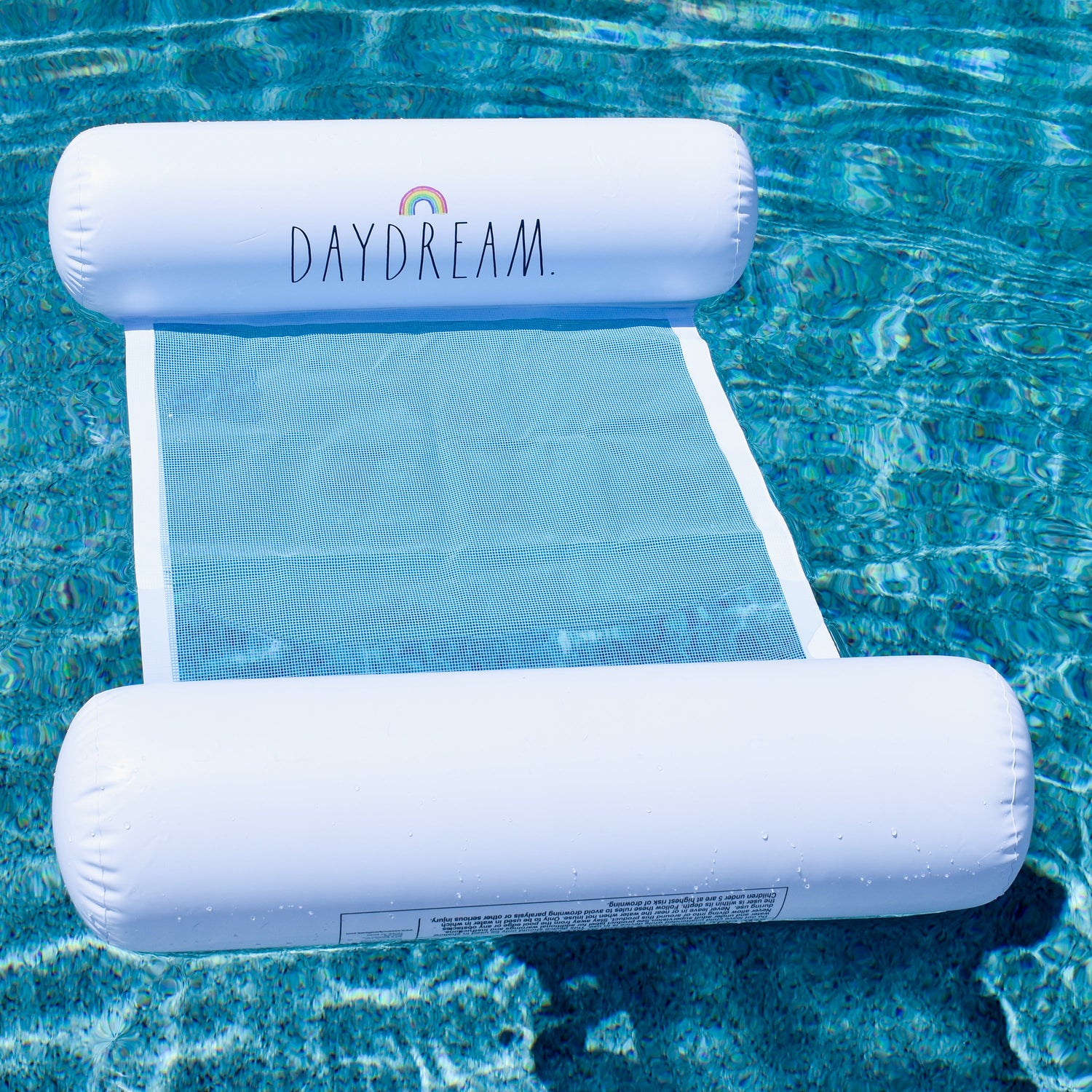 Inflatable pool lounge with 'DAYDREAM' branding floating on water