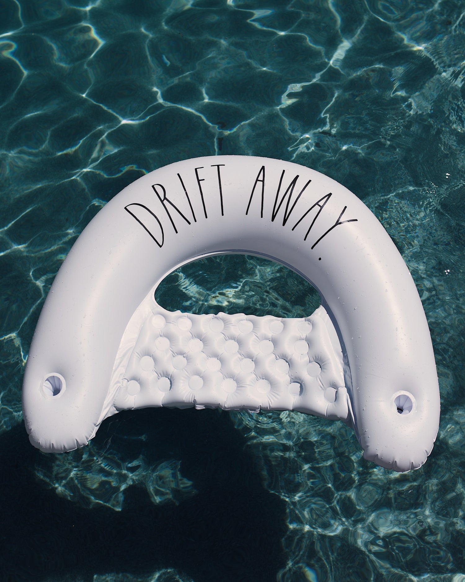 Inflatable pool float with 'Drift Away' text floating on water