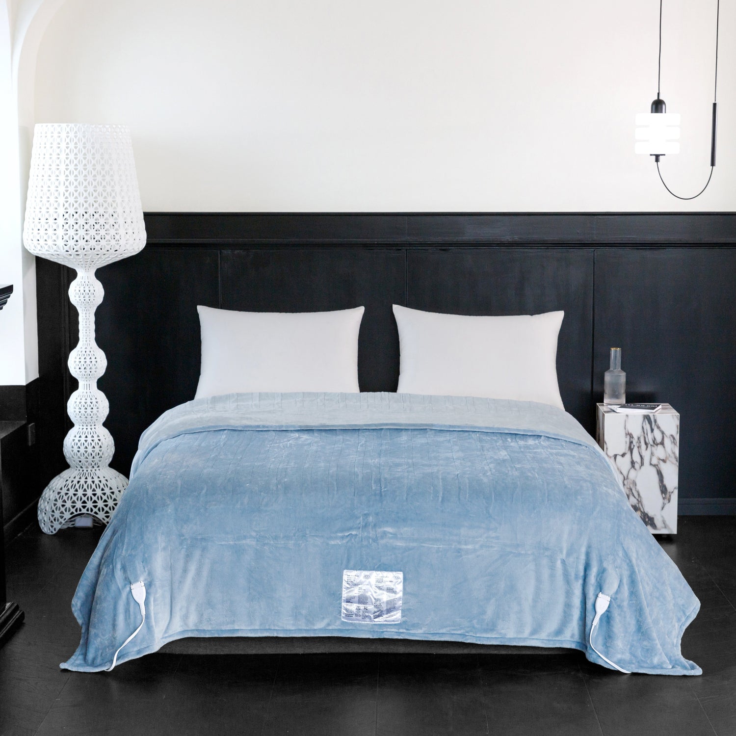 Blue blanket on a bed in a modern bedroom setting