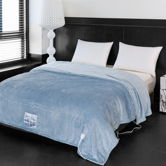 Blue blanket on a bed with white pillows in a bedroom setting