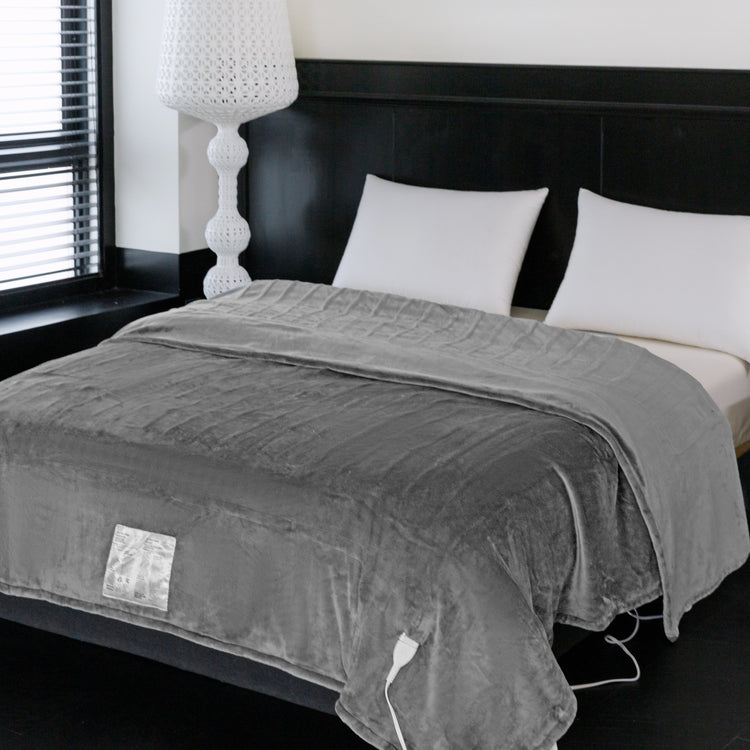 Gray electric blanket on a bed in a bedroom setting