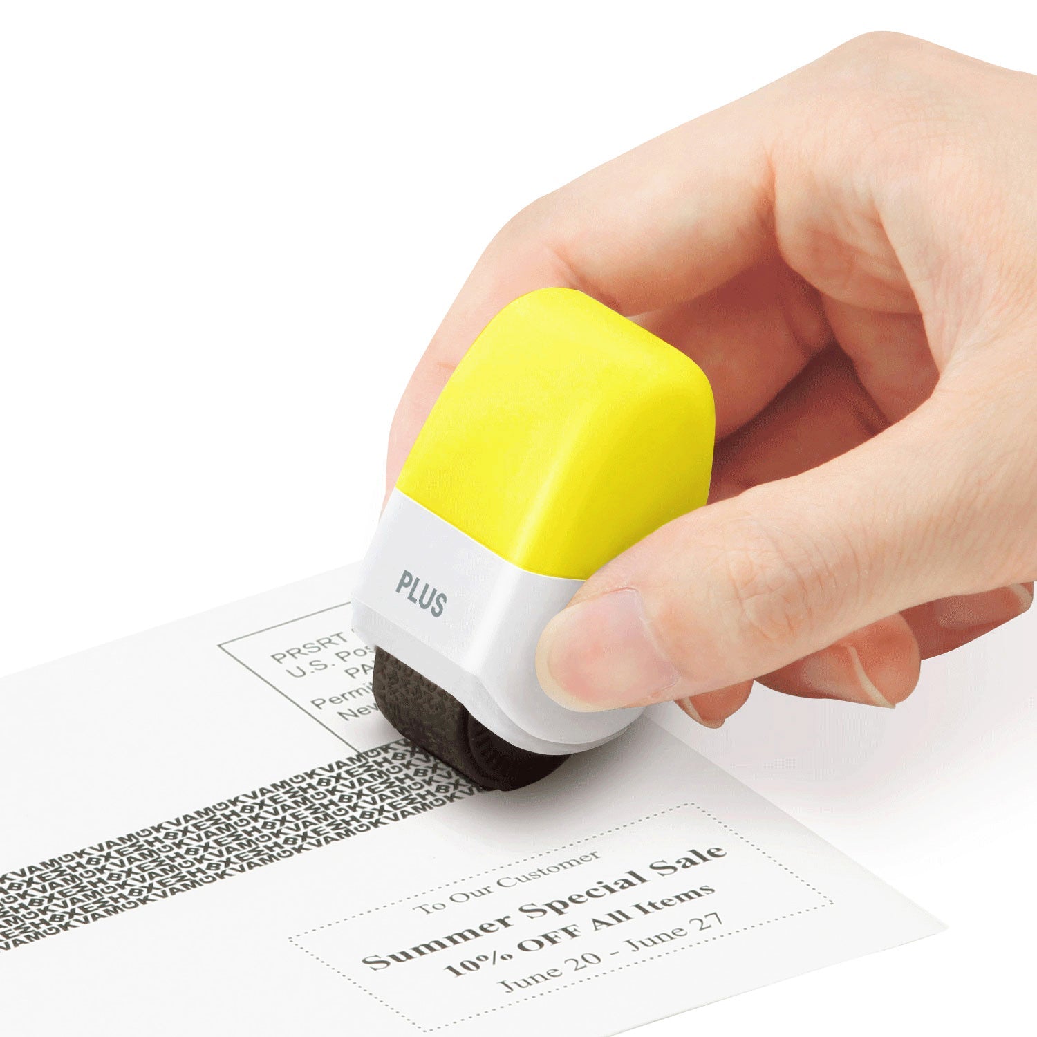 Hand using a yellow and white stamp on a document with 'PLUS' branding.