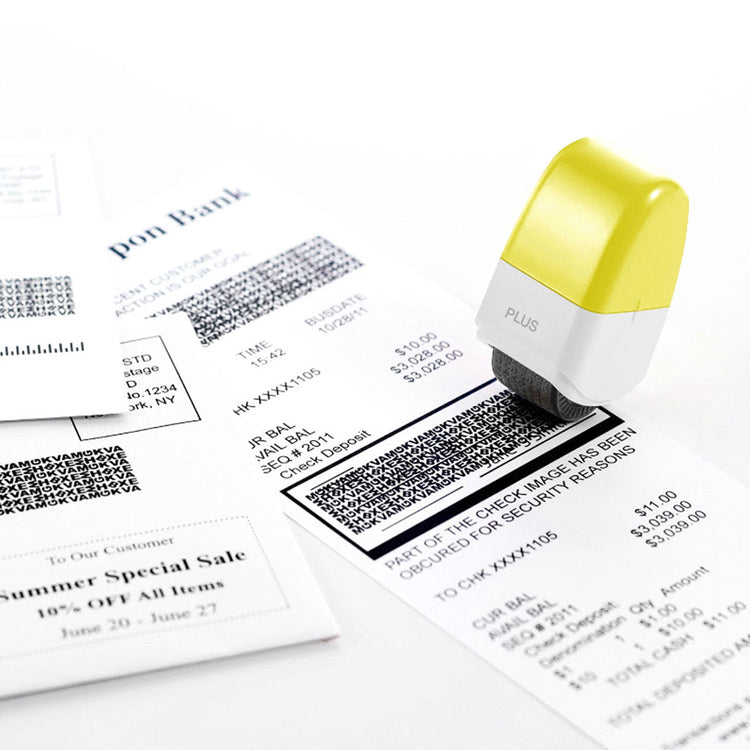 Stamp with a yellow top on a surface with printed documents featuring barcodes and text.