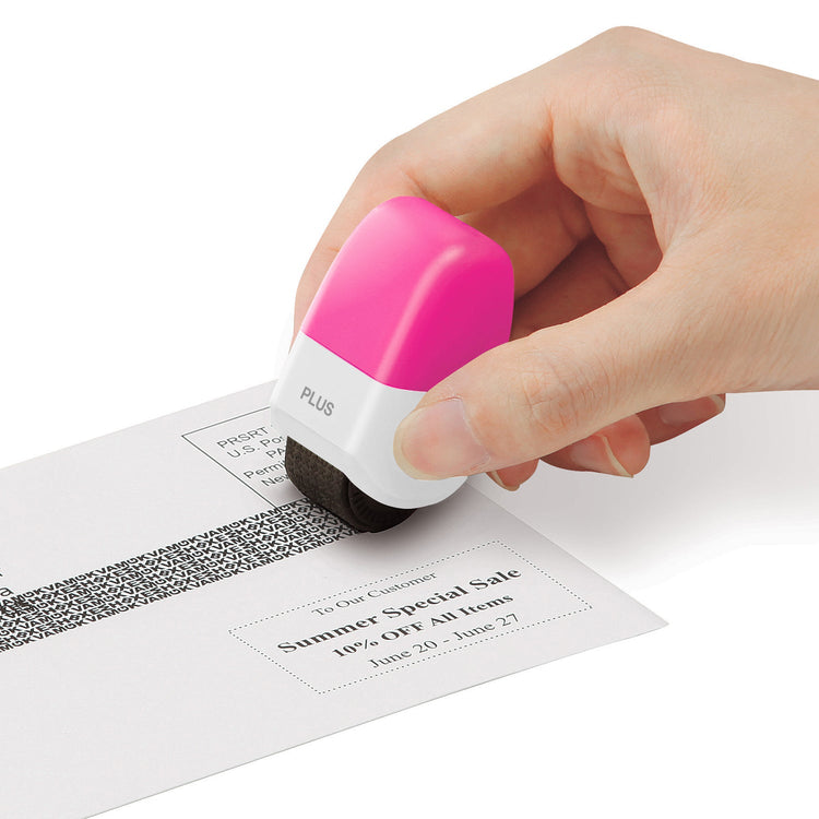 Hand using a pink and white stamp on a piece of paper with text and a barcode.