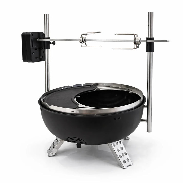 Black portable fire pit with metal stand and skewer on a white background