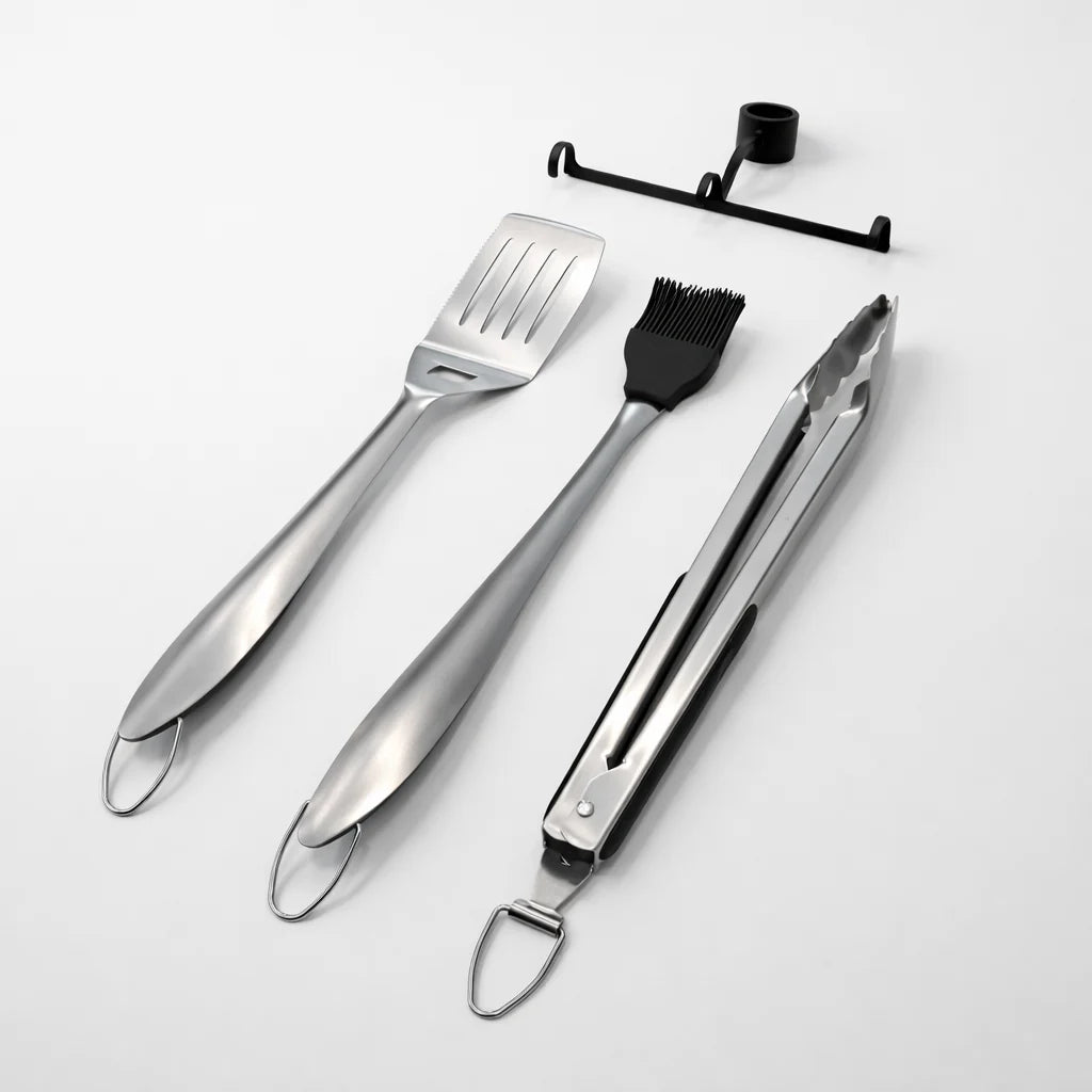 Set of stainless steel barbecue tools on a white background