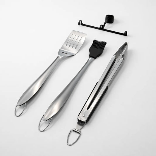 Black portable grill with cooking utensils on a white background
