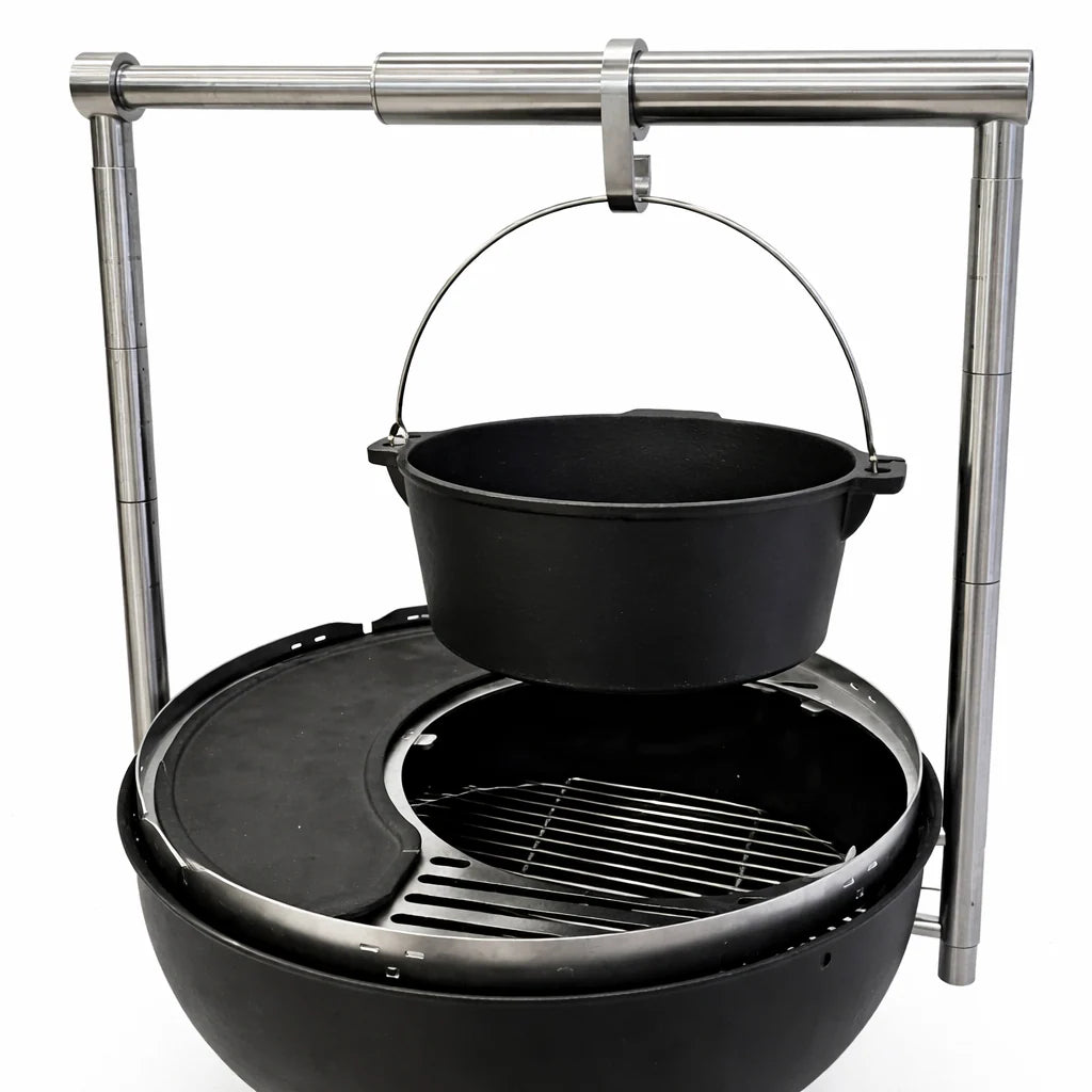 Black pot over a grill with metal stand on a white background