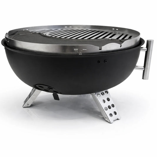 Portable grill with food being cooked on a wooden table outdoors