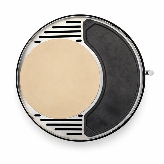 Portable pizza oven with a pizza being cooked on a stone table outdoors.