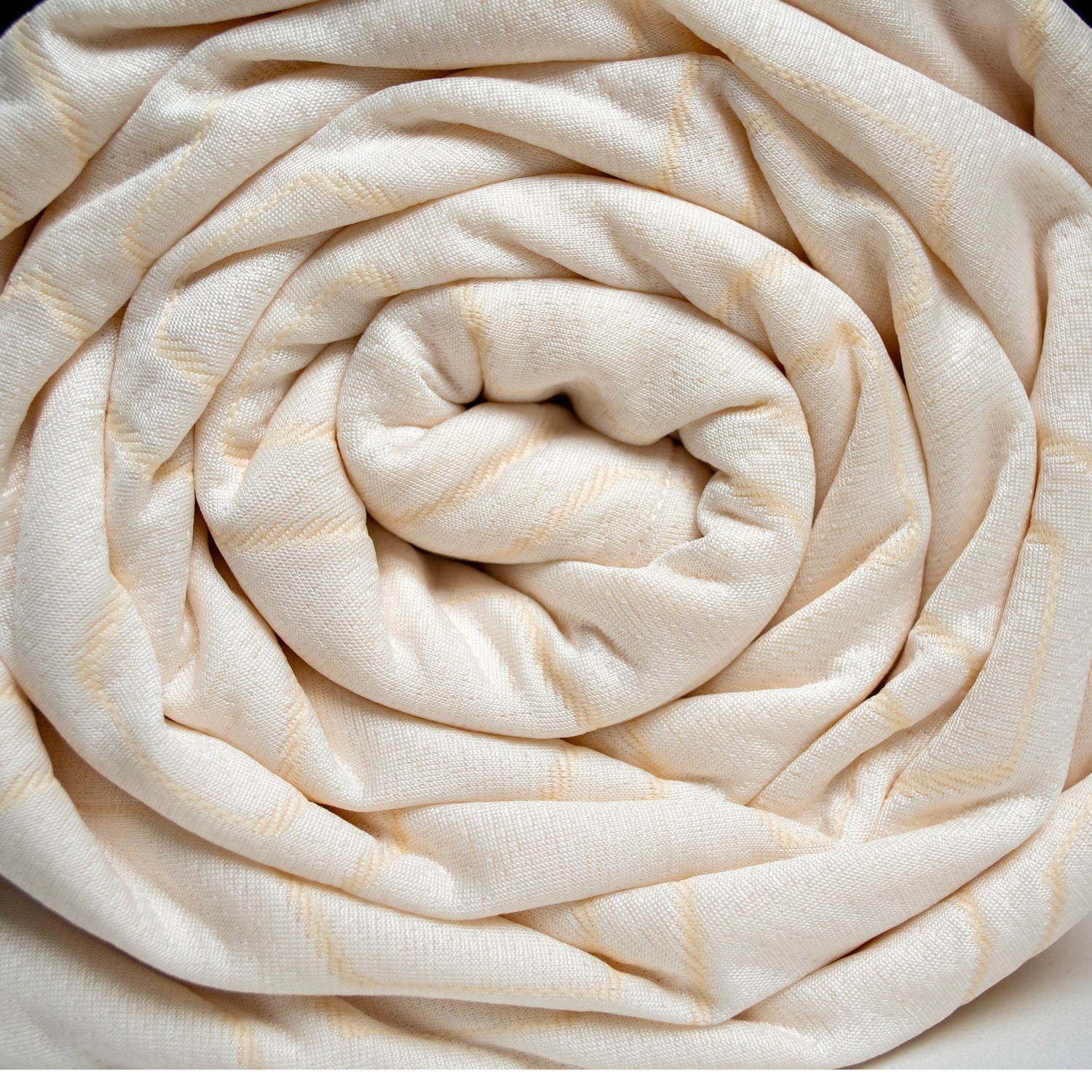Rolled-up beige fabric on a white background