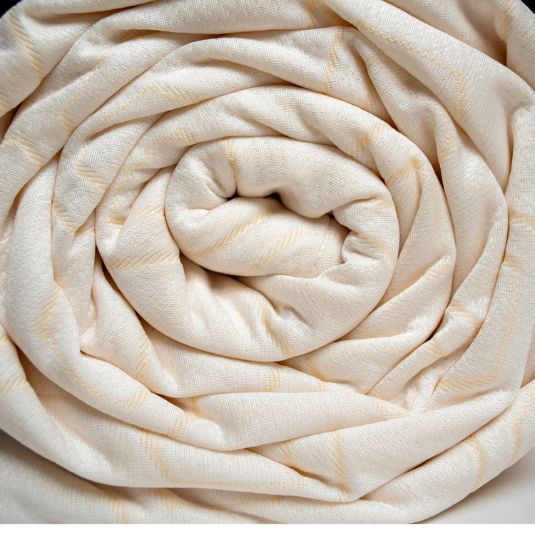 Rolled-up beige fabric on a white background