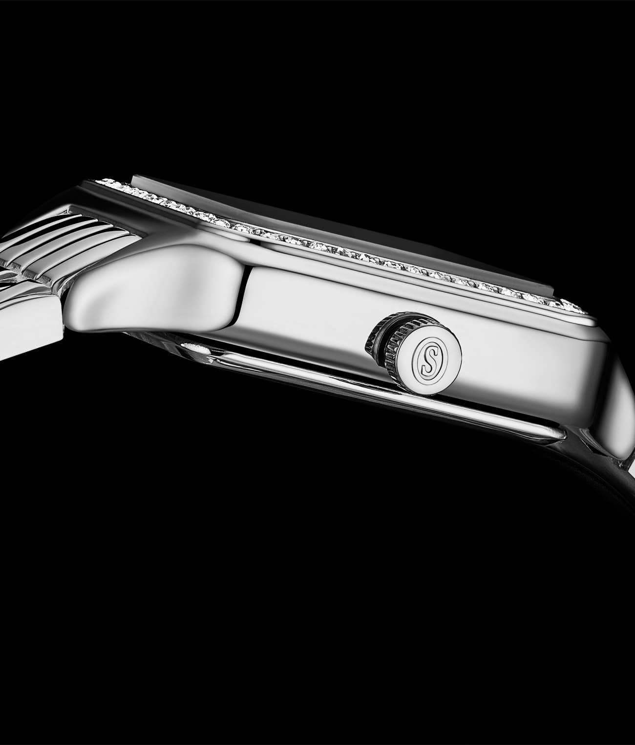 Close-up of a silver watch with a brand logo on a black background