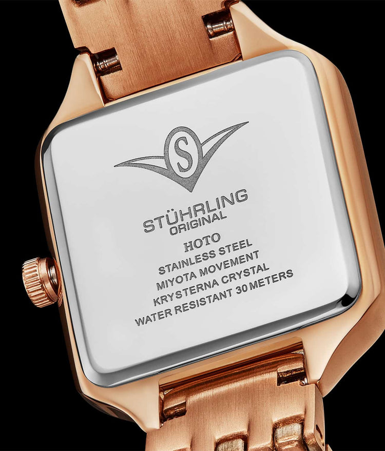 Stuhrling watch face with rose gold band on a black background