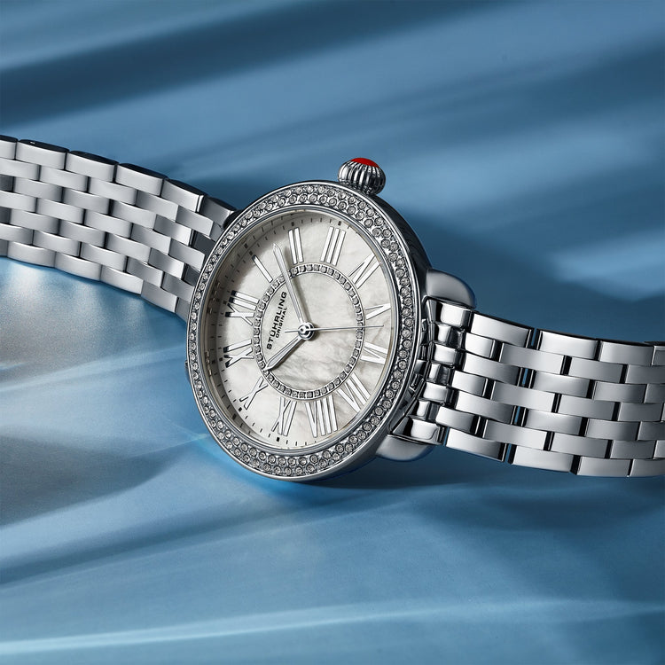 Silver watch with a detailed face on a blue background