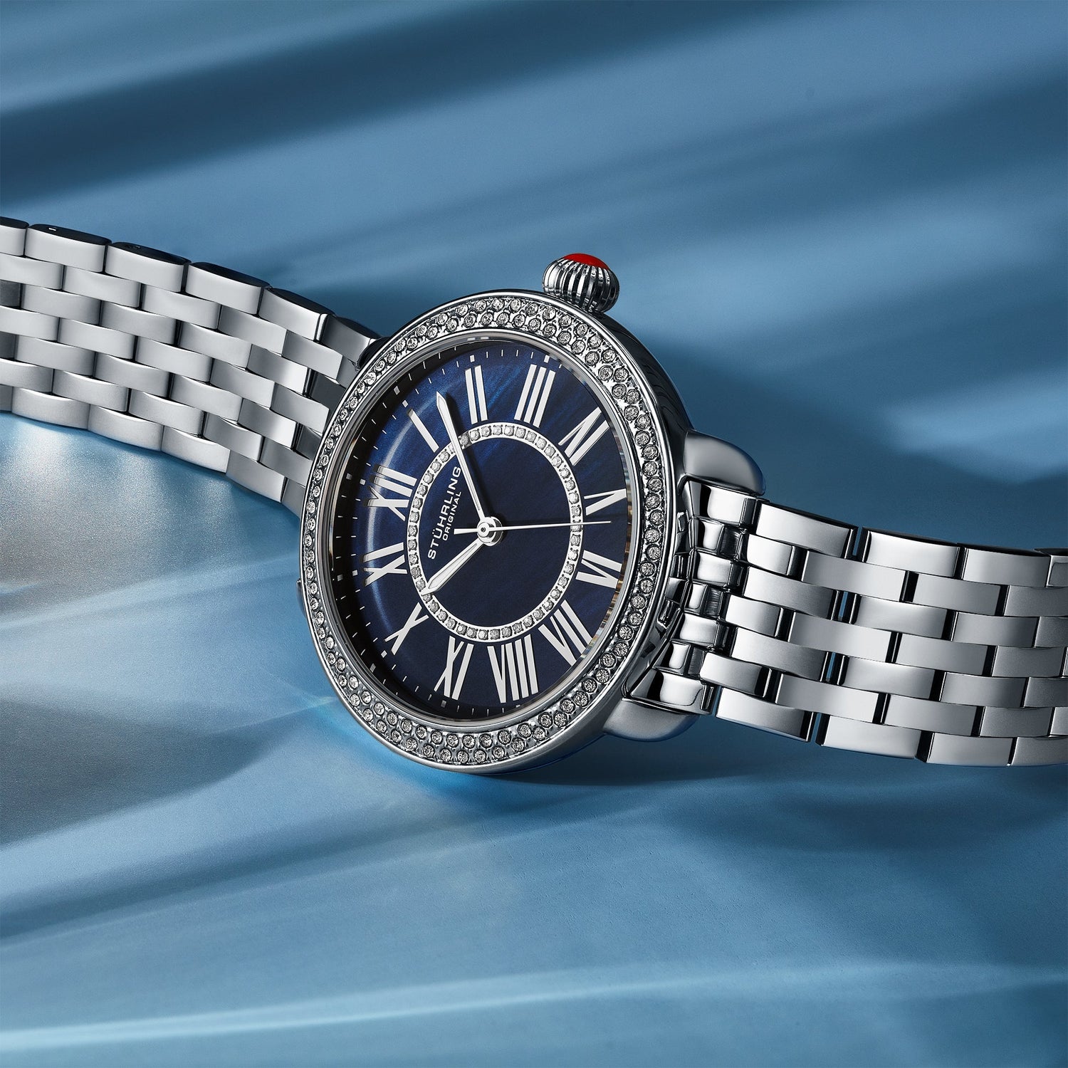 Silver watch with a blue face on a blue background