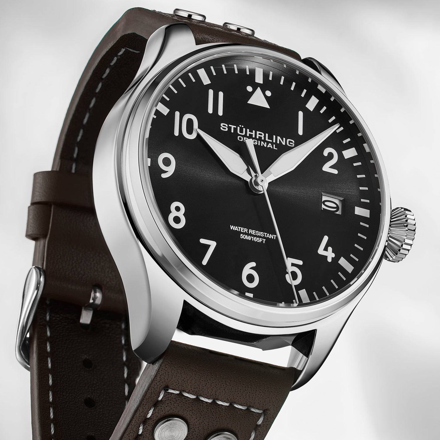 Stuhrling Original watch with black dial and brown leather strap on a white background