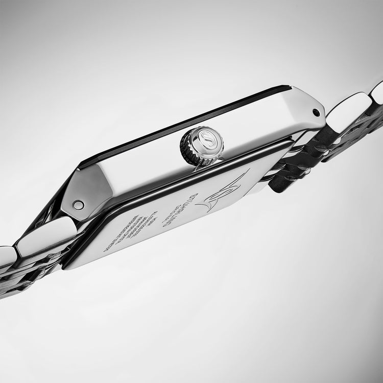 Close-up of a silver chain with a clasp on a light gray background