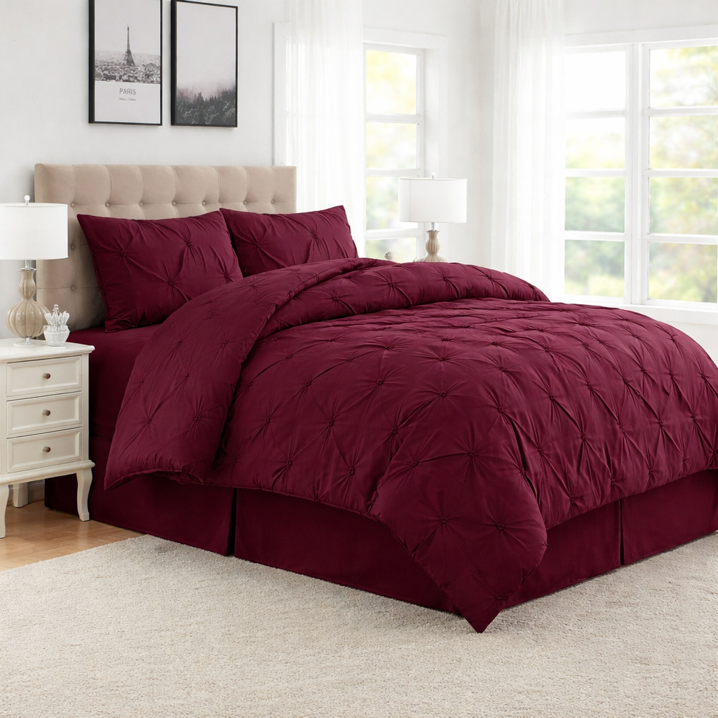 Burgundy comforter set on a bed in a well-lit bedroom.