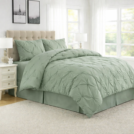 Green comforter set on a bed in a well-lit room with white walls and furniture.