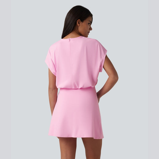 Woman wearing a pink dress against a plain background