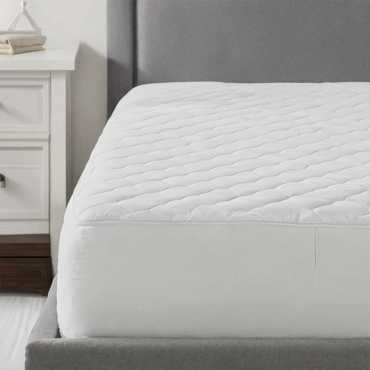Mattress protector on a bed in a bedroom setting