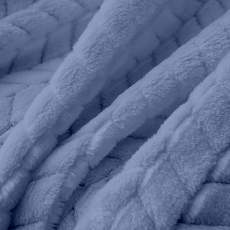 Close-up of textured blue fabric with a quilted pattern