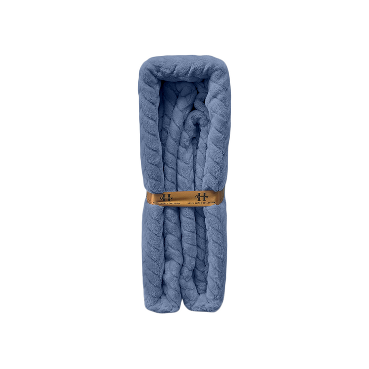 Blue folded blanket with a wooden ring on a white background