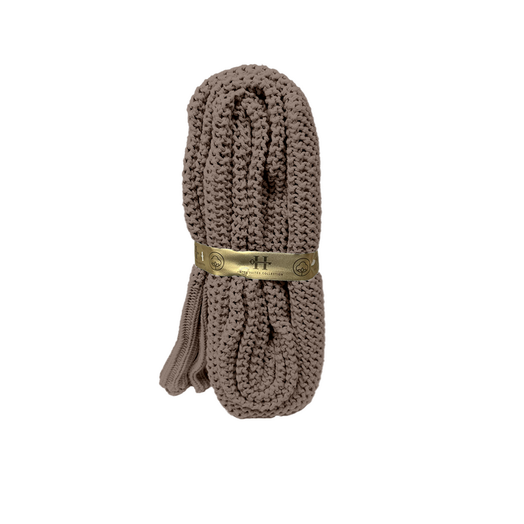 Brown shoelace with a gold label on a white background