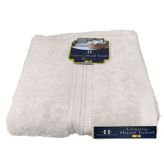 Stack of white luxury hand towels with brand label on a white background