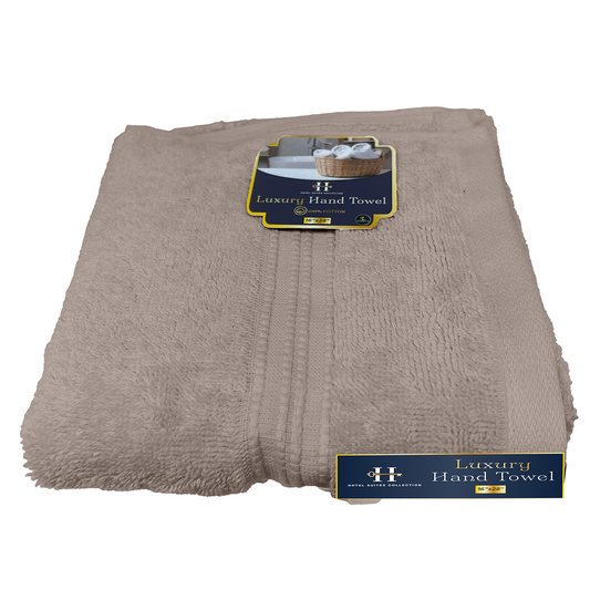 Folded beige towel with 'Luxury Hand Towel' label on a white background
