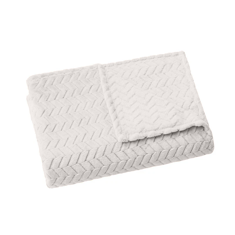 Folded textured blanket on a white background