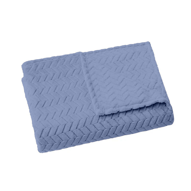Folded blue textured blanket on a white background