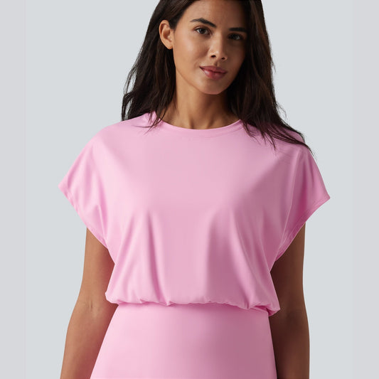 Woman wearing a pink dress against a plain background