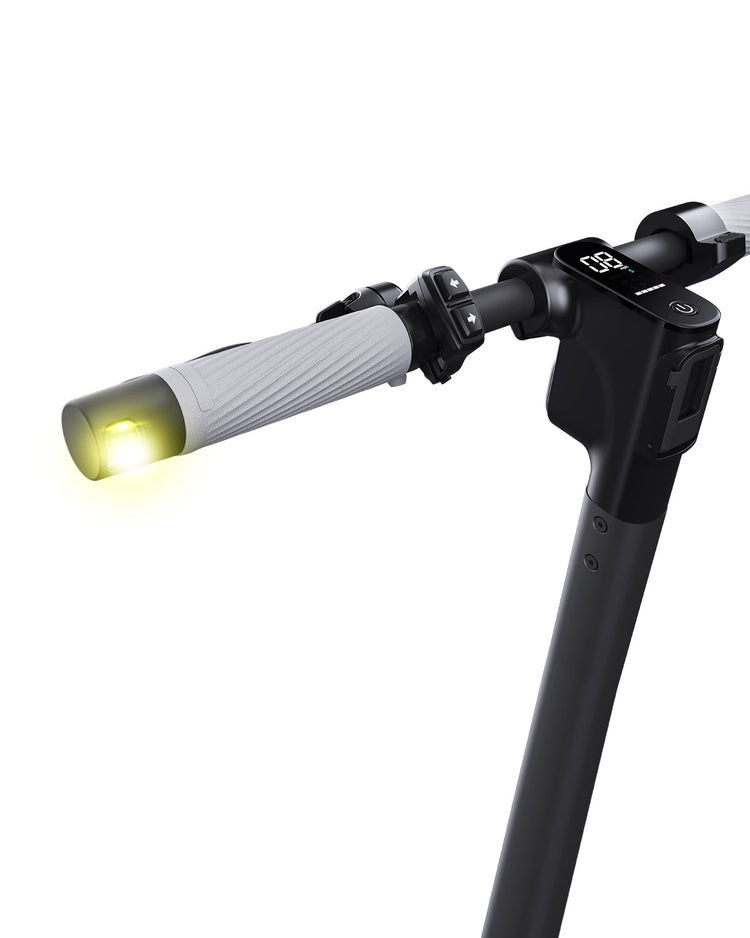 Close-up of a scooter handle with a light on a white background
