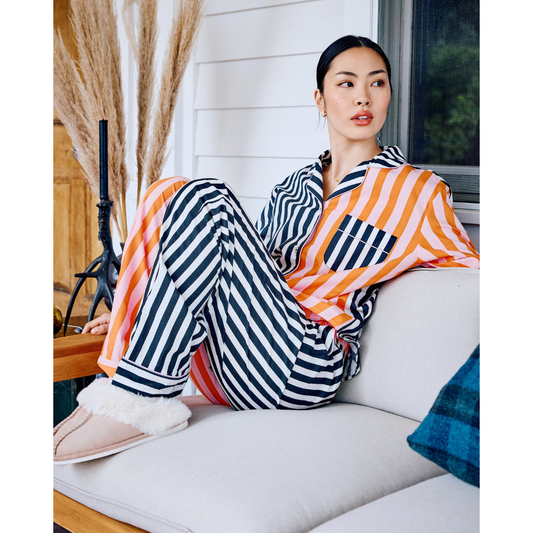 Woman wearing a colorful striped shirt against a white background
