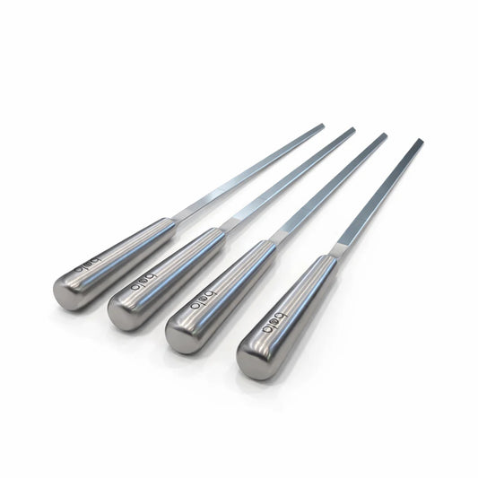 Black portable grill with metal skewers on a white background