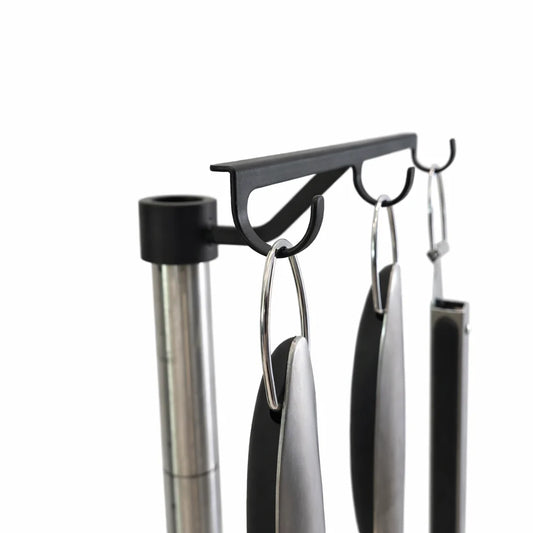 Black portable grill with cooking utensils on a white background
