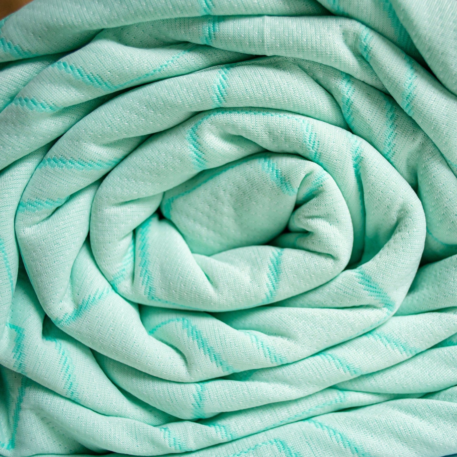 Rolled-up light blue fabric with subtle patterns