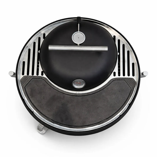 Grill with various foods on a dark surface