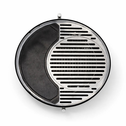 Portable grill with food being cooked on a wooden table outdoors