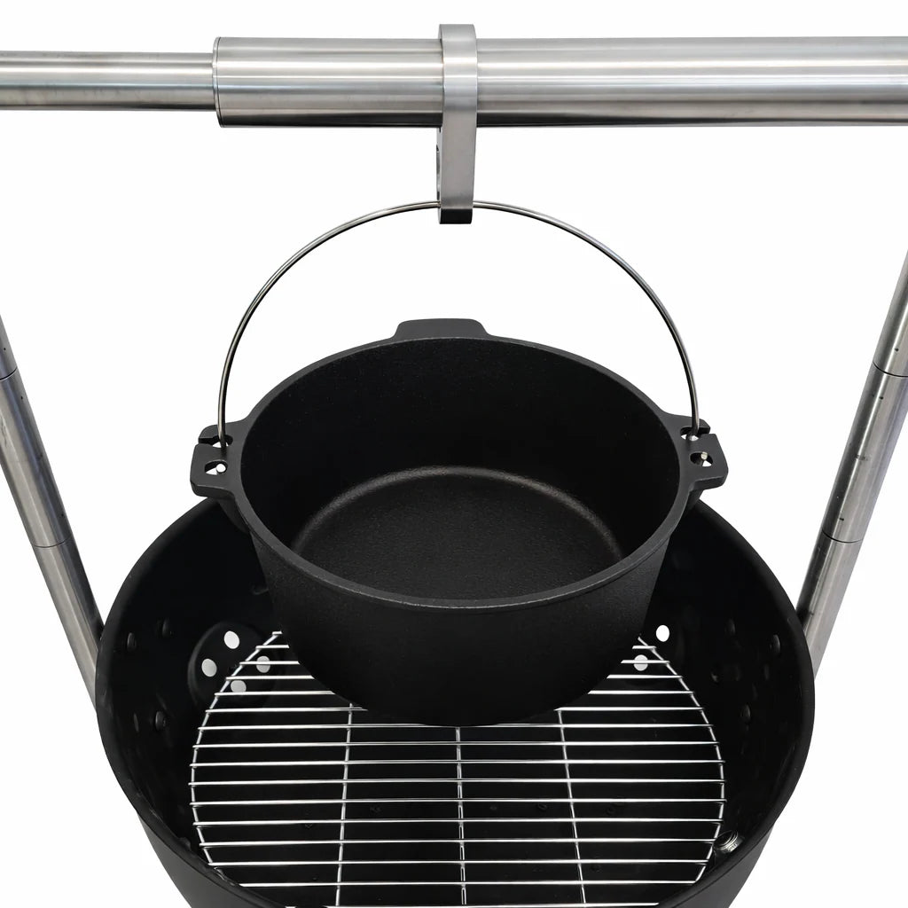 Black pot hanging over a grill with a white background