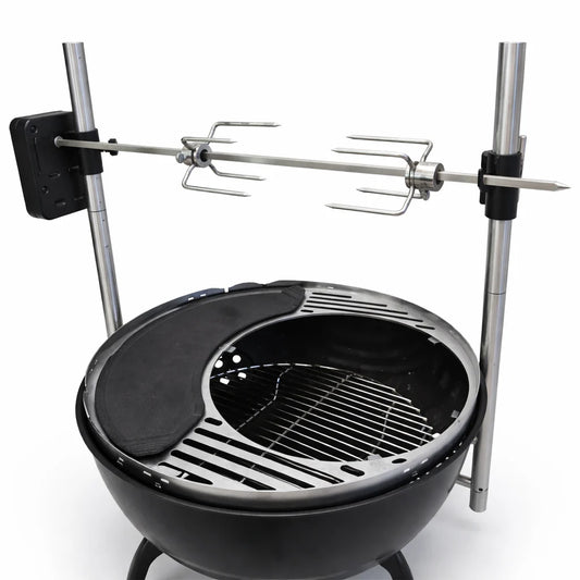 Grill with skewers of meat over an open flame on a wooden deck.
