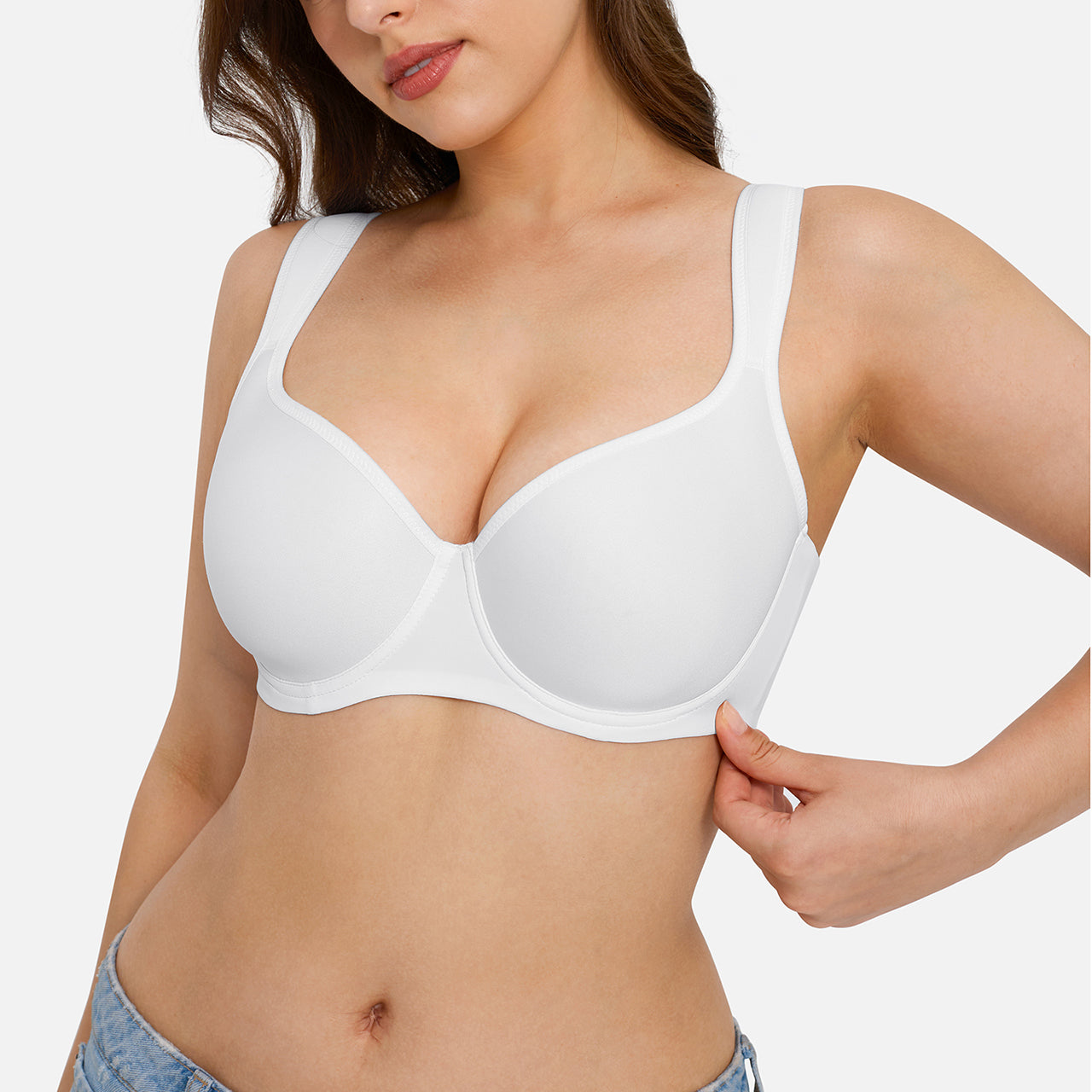 A woman wearing a white wireless underwire bra, shown from the chest to the hips against a light gray studio background.