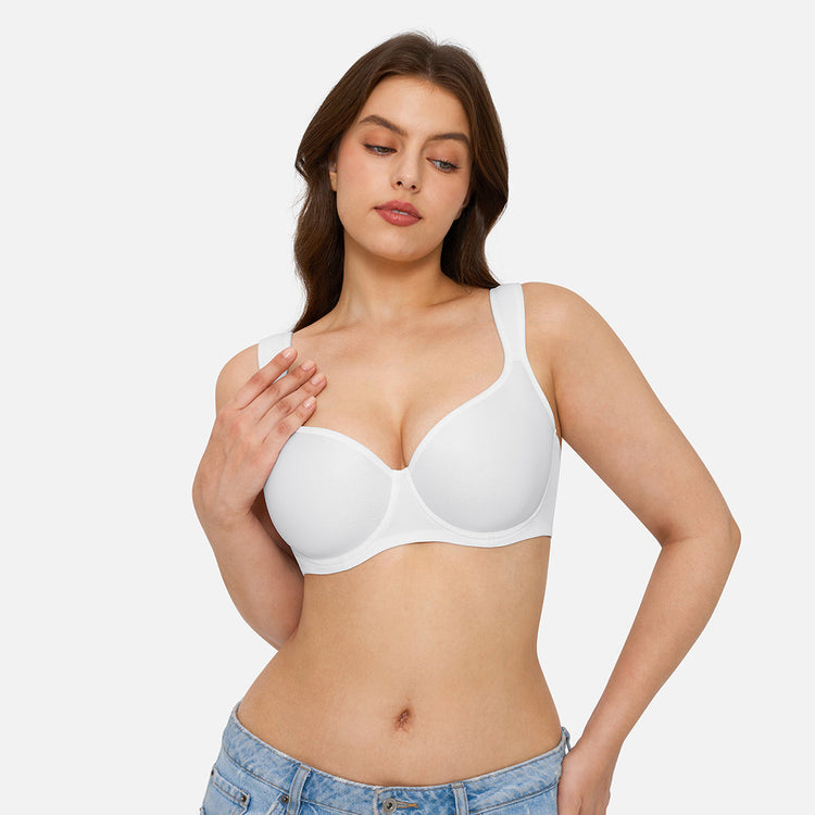 A woman modeling a white seamless underwire bra against a light gray studio background.