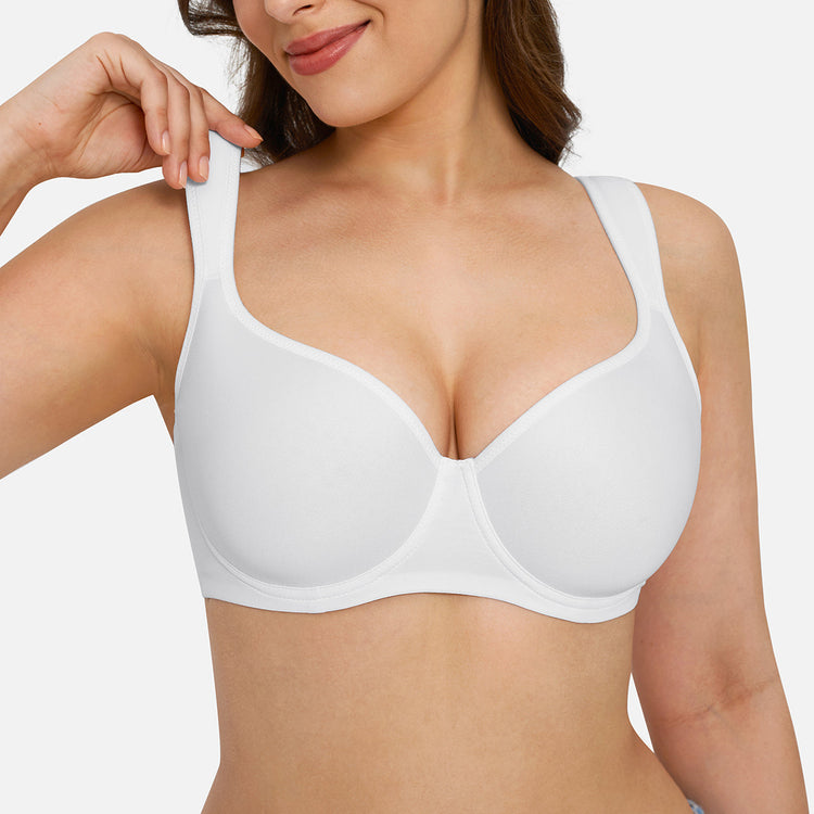 A close-up of a woman wearing a white wireless underwire bra against a light gray studio background.